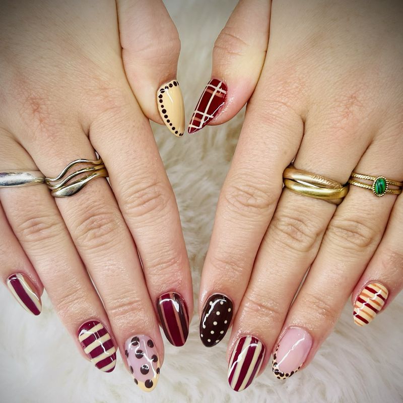 Autumn nail art with burgundy and beige stripes and dots
