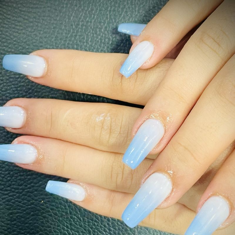 Long nails with a white to sky blue gel polish ombré