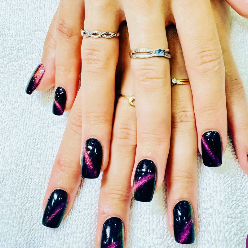 Black nails with a pink cat-eye effect
