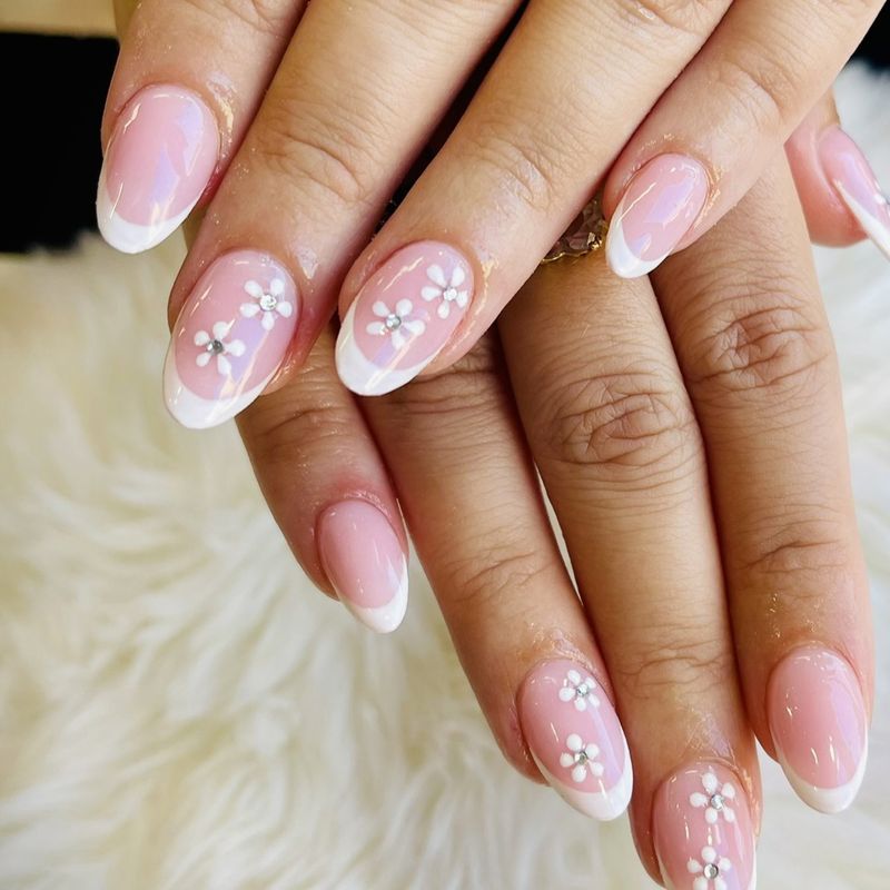 White French tips with flowers and rhinestones