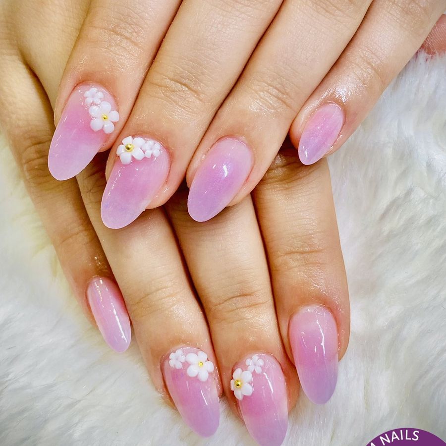 Pink and lilac nails with small white flowers, done at Kim Nails
